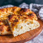 baked sourdough discard pizza crust with golden bubbles