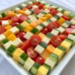 Checkerboard salad with colorful vegetables arranged in a grid