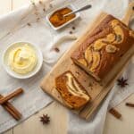 Cream Cheese Swirled Pumpkin Loaf sliced with visible cream cheese ribbon
