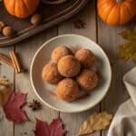 Pumpkin Donut Holes: Bite-Sized Fall Comfort 8 Pumpkin donut holes freshly baked on a plate