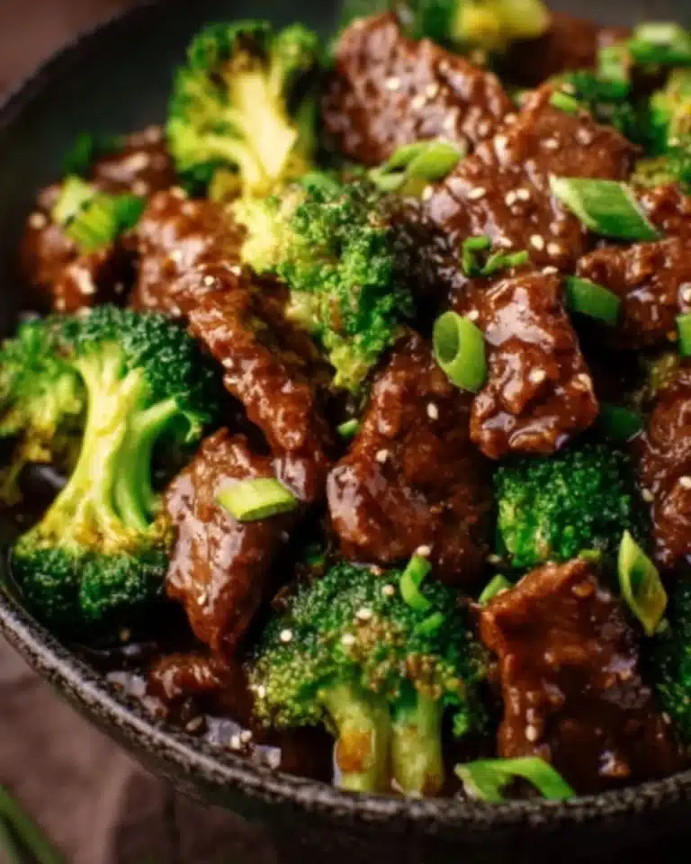 Crockpot Beef and Broccoli 2 Crockpot Beef and Broccoli served on a plate with a side of rice