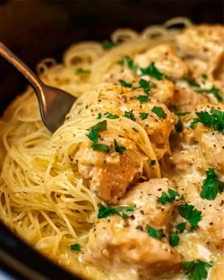 Crock Pot Angel Chicken 2 Crock Pot Angel Chicken dish served with a creamy sauce and herbs.