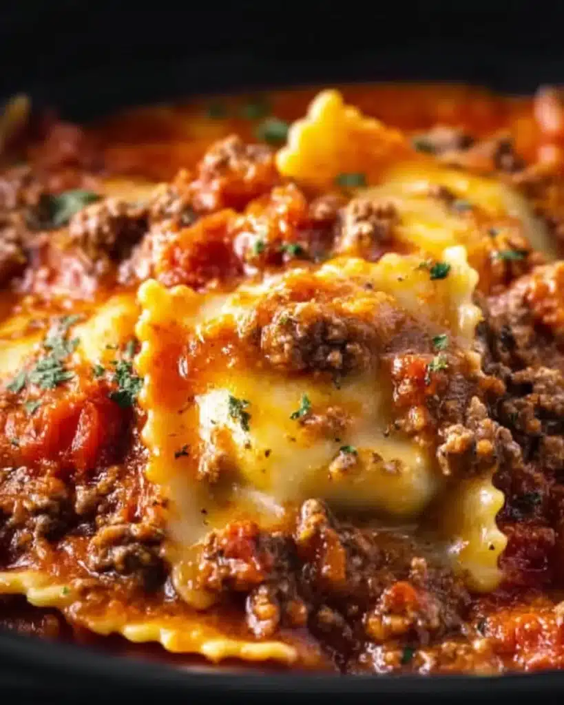 Crockpot Ravioli Lasagna served in a dish, showcasing layers of pasta and cheese.
