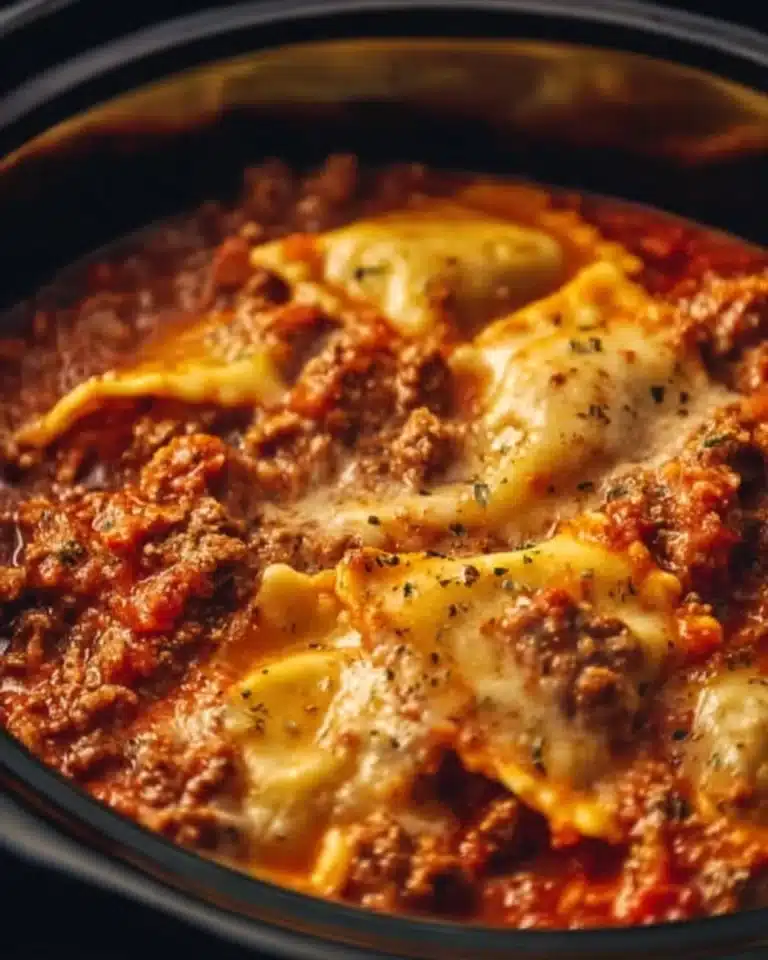 Crockpot Ravioli Lasagna: A Hands-Off, Flavor-Packed Comfort Food Masterpiece 2 Crockpot ravioli lasagna served on a plate with fresh basil garnish.