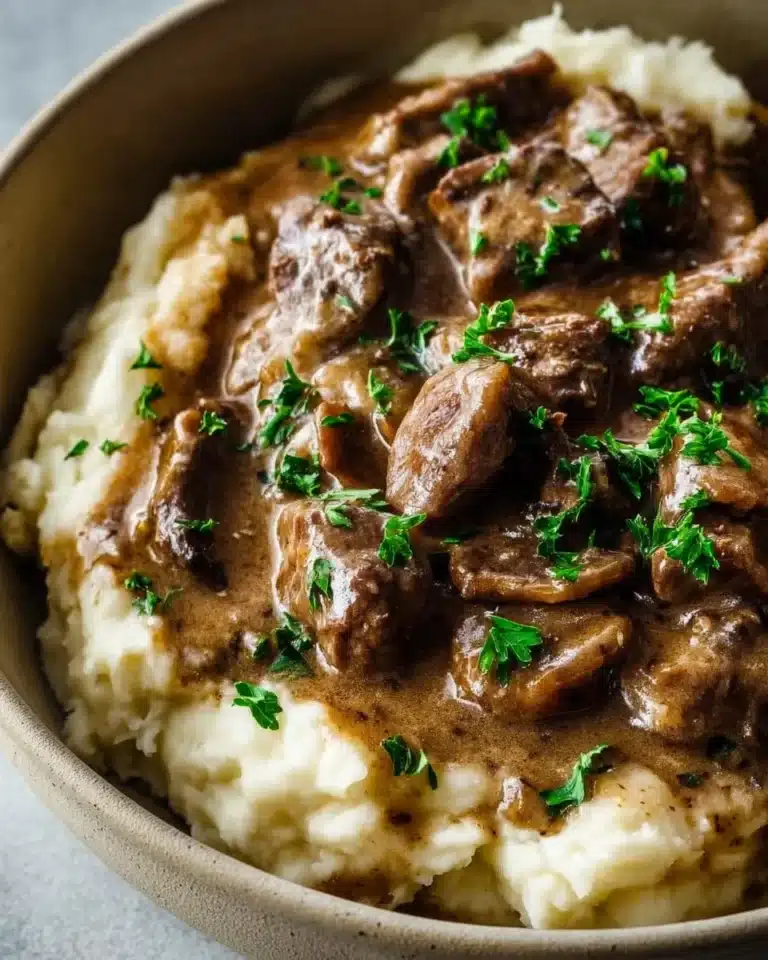 Delicious Keto Crockpot Beef Stroganoff served in a bowl with mushrooms and pasta.