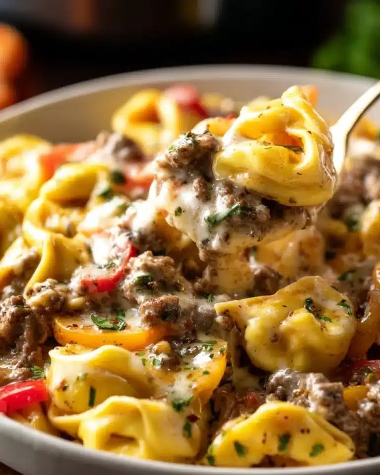 Crock Pot Cheesesteak Tortellini 2 Crock Pot Cheesesteak Tortellini with cheese and peppers in a bowl