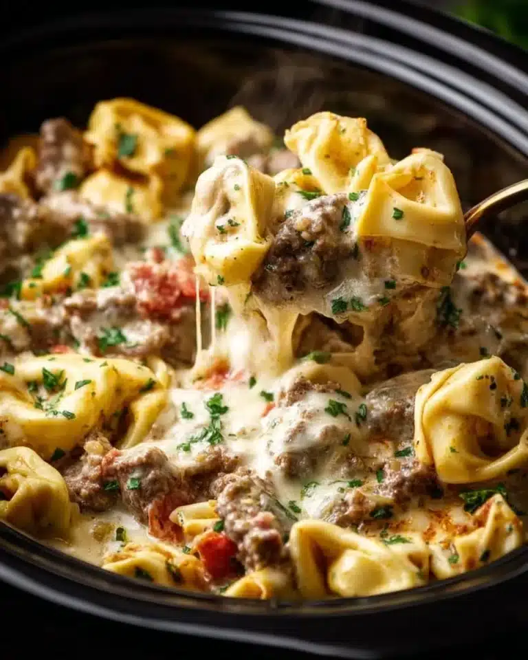 Crock Pot cheesesteak tortellini dish garnished with herbs