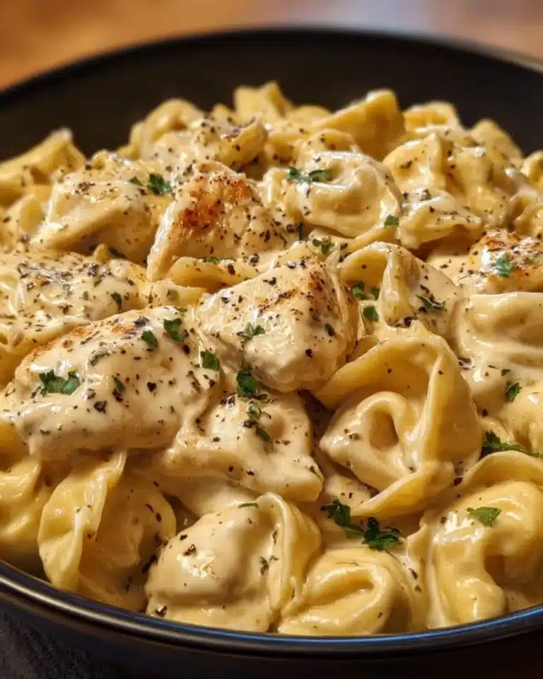 Crockpot Chicken Alfredo Tortellini served in a bowl with garnish