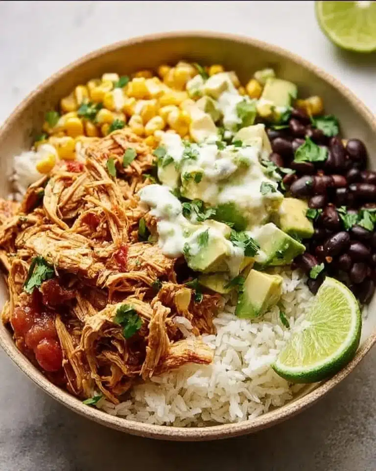 Delicious Slow Cooker Chicken Burrito Bowl topped with fresh ingredients.