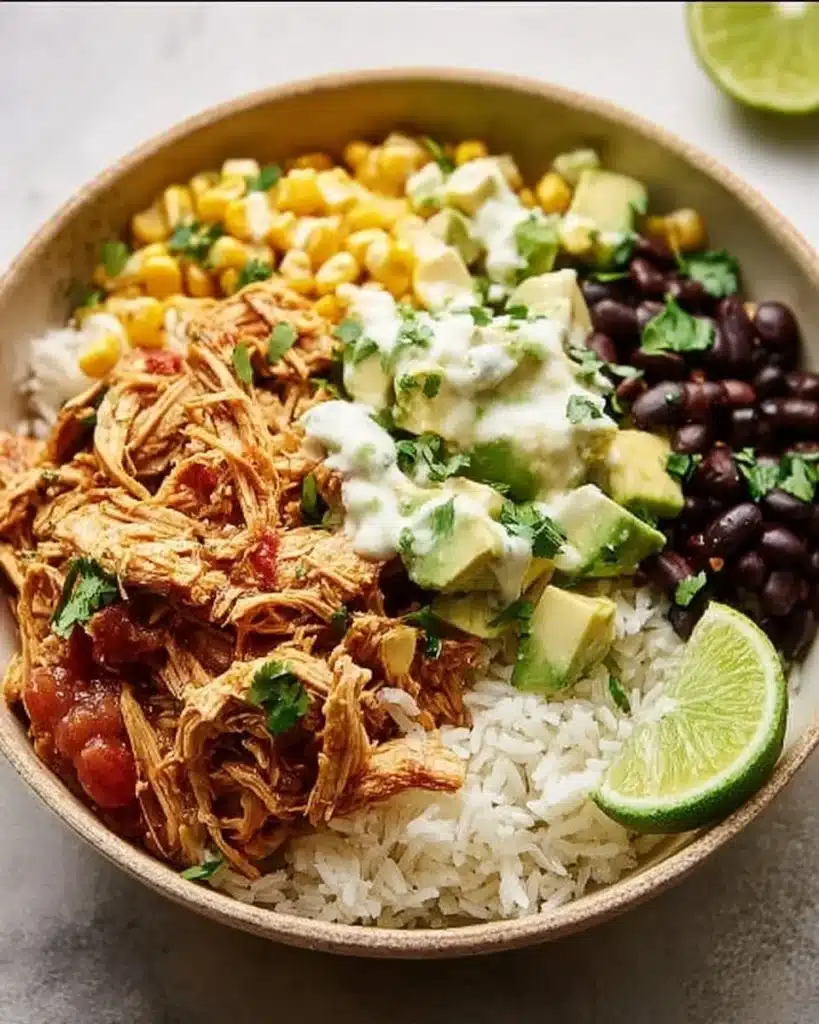 Delicious Slow Cooker Chicken Burrito Bowl topped with fresh ingredients.