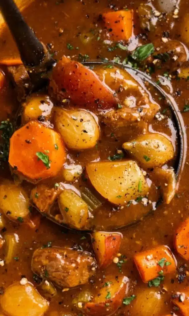 Delicious beef stew in a bowl with vegetables and herbs