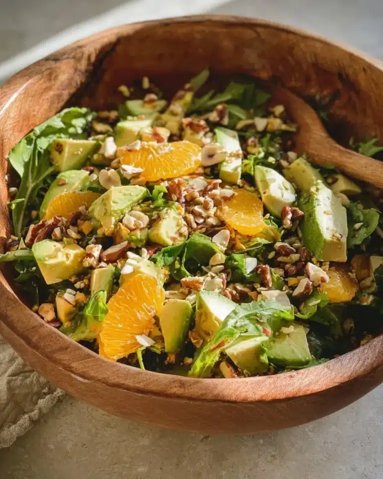 Delicious arugula citrus salad with fresh ingredients in a bowl.