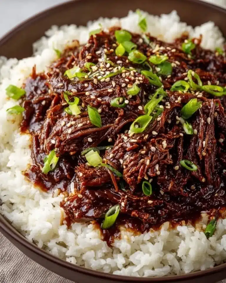 Delicious bowl of Slow Cooker Korean Beef served with rice and vegetables