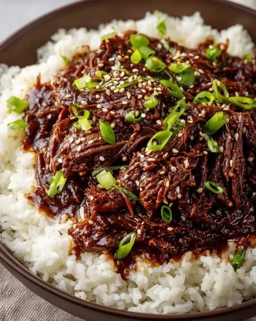 Delicious bowl of Slow Cooker Korean Beef served with rice and vegetables